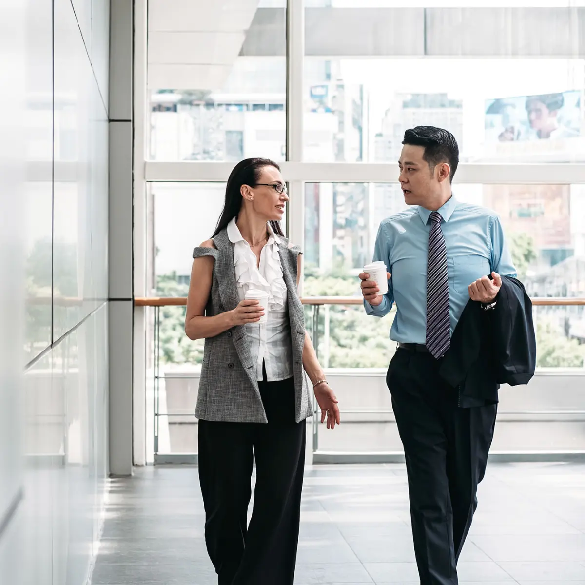 image of two in conversation while walking