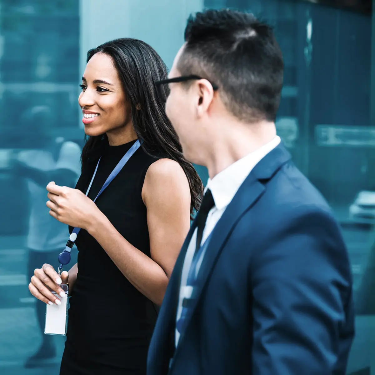 image of two in conversation while walking outside