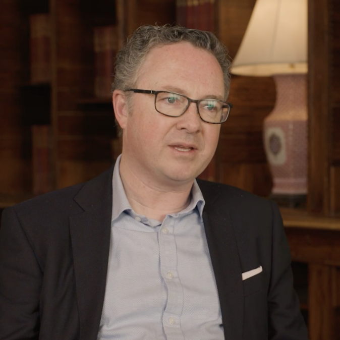 video_thumbnail_of_man_in_blazer_being_interviewed