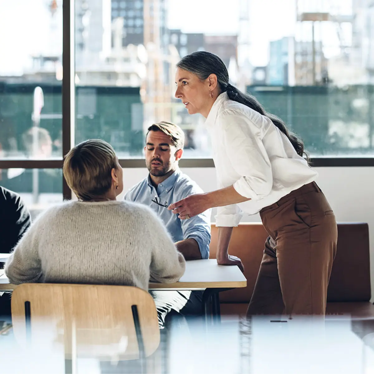 image of woman standing up in a meeting
